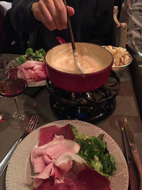A three cheese fondue, with everything ready to be dipped into it