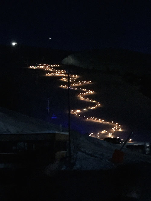 A huge number of torch-lit skiers take to the slopes in tribute to Adrien